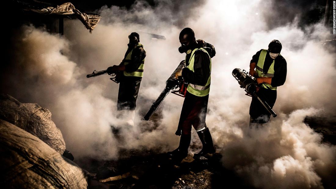 Workers in Nairobi, Kenya, fumigate the streets and the stalls of the City Park Market on April 15.